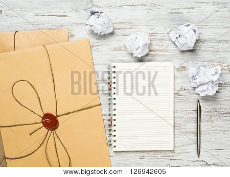 Top view of creative writing concept with papers on wooden table