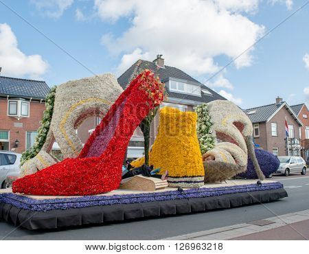 HILLEGOM, THE NETHERLANDS - APRIL 23, 2016: Moving platform with a frame made in a form of boots and shoes decorated with spring flowers. Taking part in the  traditional flowers parade 