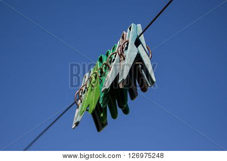 colorful clothespins hanging in a row on clothesline