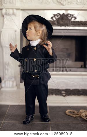 Girl as a chimney sweep against fireplace. Lucky New Year's Eve and New Year.
