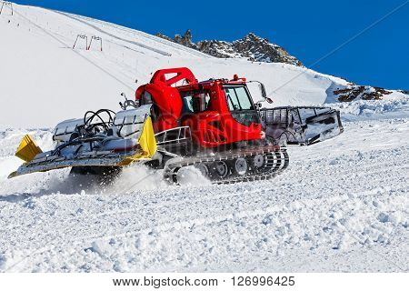 Photo of red snowcat in action on the ski