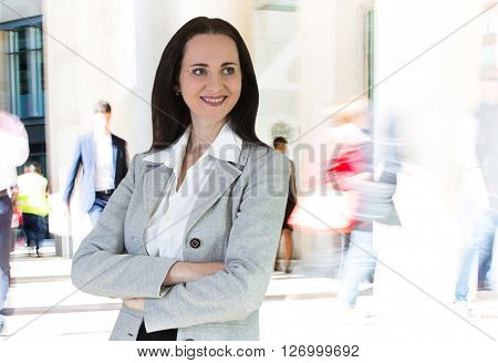 Beautiful business woman portrait and people blur on the background. Modern business life concept