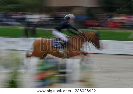 Abstract Image With A Moving Rider And Horse At Show Jumping On Blurred Background, Herneacova, Roma