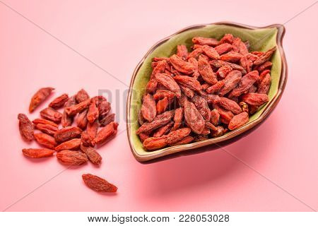 a small, leaf shaped bowl of dried red Tibetan goji berries (wolfberry) - superfruit