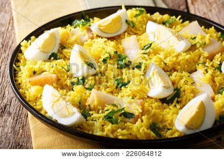 Kedgeree Curry Rice With Smoked Fish, Eggs, Cilantro Close-up On A Plate. Horizontal