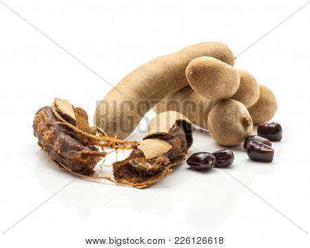 Three Tamarind In A Brittle Shell And One Cracked With Brown Jelly Flesh And Glossy Seeds Isolated O