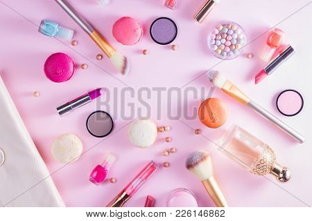 Make Up Products And Macaroons On Pink Background Flat Lay Scene