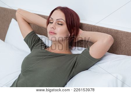 Calm Beautiful Woman Relaxing In Bed Enjoying Weekend. Meditative Girl With Closed Eyes Holding Hand