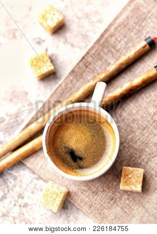 Cup of coffee on rustic background and two brushes Fude for Sumi-e painting