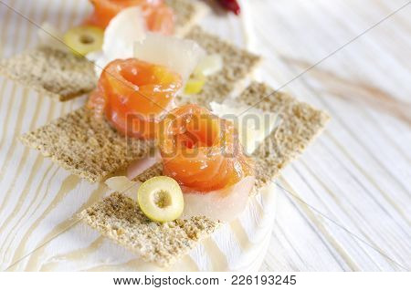 Delicious Appetizer Canapes With Salmon, Cheese And Olive.