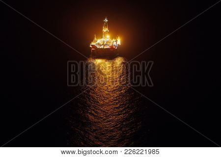offshore oil platform at night