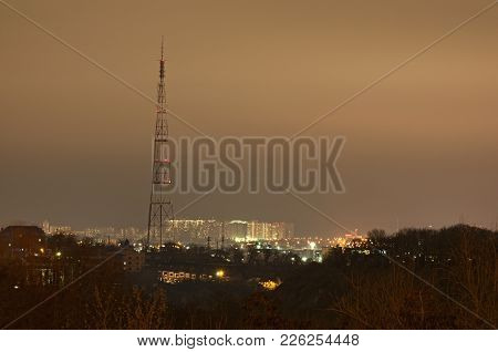 High Antenna On Top Of The Hill. Residential Buildings Of The Obolon District At Background  Evening