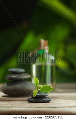 Close Up View Of Gray Stones  And Massage Oil On Color Back