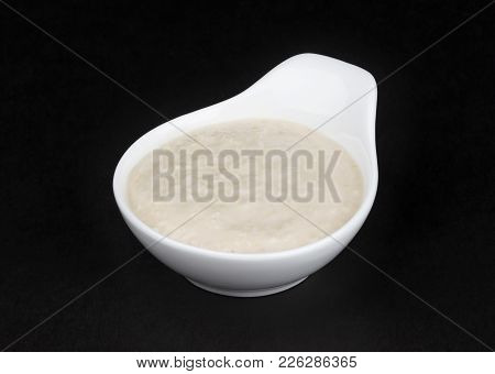 Horseradish Sauce In White Bowl Isolated On Black Background