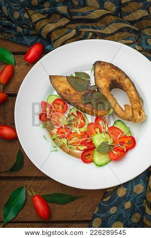 Grilled Fish Steak With Vegetables On Plate: Tomatoes, Microgran, Cucumber, Tasty And Healthy Dinner
