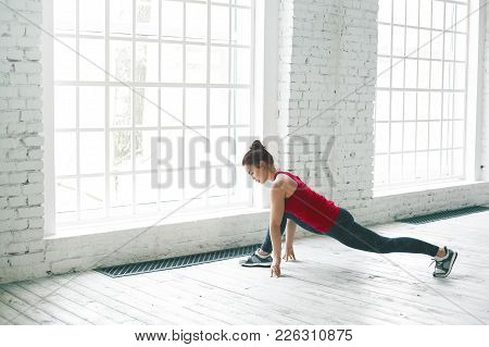 Portrait Of Serious Concentrated Young Female Yogi With Beautiful Prefect Athletic Body Exercising A