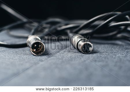 Xlr, Connector With Wires On A Dark Fabric Background In The Studio