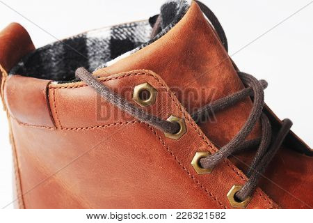 Winter Brown Leather Boots On A White Background. Modern Fashion And Style. Bootlace Closeup.