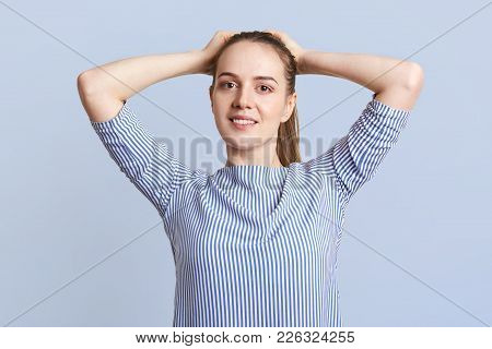 Portrait Of Pretty Female Student With Pleasant Smile And Attractive Look, Dark Hair Tied In Pony Ta