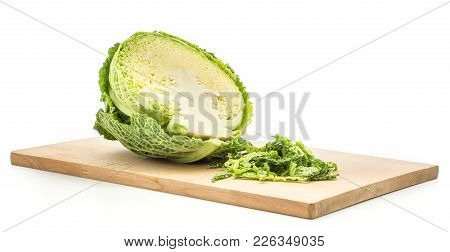 One Savoy Cabbage Half On A Chopping Board With Fresh Green Chopped Leaves Isolated On White Backgro