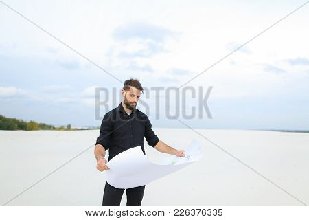 Archeologist Male Come To Village For Excavations, Young Man Reviewing Plan Talking With Colleagues.