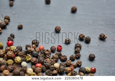 Mixture Of Pepper Peas Powder Scattered On A Slate Plate. Closeup
