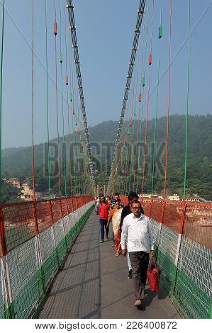 Rishikesh, India - November, 7th, 2017. Bridge Over Ganga River, Ram Jhula, Rishikesh. People Crossi