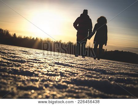 Couple Holding Hands In Winter Sunset. Lovers Standing Together Through Hard Times, Relationship Cha