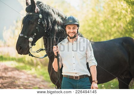 Young Man With A Horse. Autumn Outdoors Scene