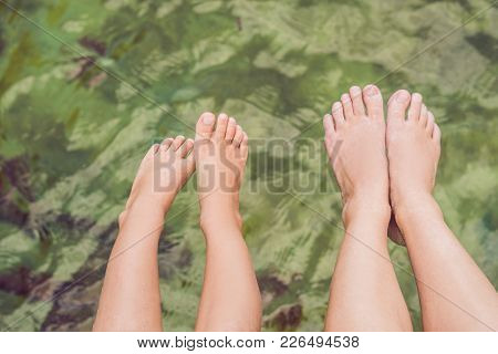 Legs On The Old Pier On The Background Of The Sea.