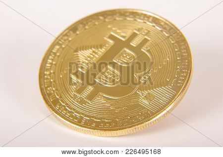 Golden Coin As A Symbol Of Bitcoin Crypto Currency Isolated On The White Background