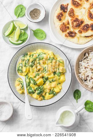 Vegetarian Chickpea, Spinach, Potato Curry, Wild Rice And Naan Flatbread On White Background, Top Vi
