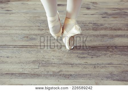 Young Ballerina Dancing, Closeup On Legs And Shoes, Standing In Pointe Position.