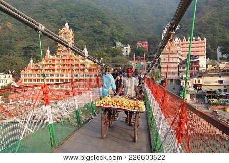 Rishikesh, India - November, 9th, 2017. Lakshman Jhula Bridge And Tera Manzil Temple, Trayambakeshwa