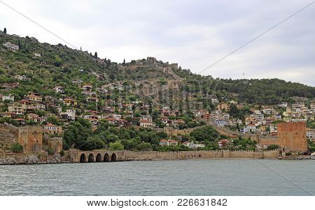 Shipyard And The Ruins Of A Medieval Fortress On The Mountainside In Alanya, Turkey