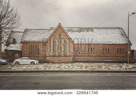 Broken Windows And Decaying Roof On A Now Abandoned Church In The Scottish Town Of Clydebank.