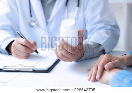 Madicine Doctor Giving Pills To Patient At A Hospital / Clinic