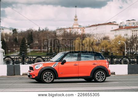 Minsk, Belarus - April 7, 2017: Orange Color Mini Cooper All 4 Car With Woman Driver In Fast Motion 