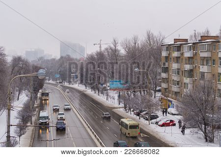 Russia, Rostov On Don, February 13, 2018: Road Traffic In Snowfall Time At Street In The City.
