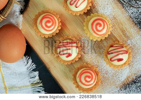 High Angle View Of Egg Tarts On The Wooden Board.