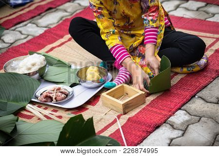 Child Wear Traditional Dress Ao Dai Learning To Make Chung Cake By Hands Closeup, Chung Cake Is The 