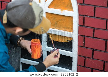 Man Painting Play House Made Of Styrofoam Closeup