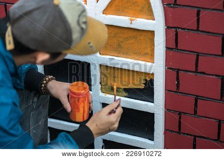 Man Painting Play House Made Of Styrofoam Closeup