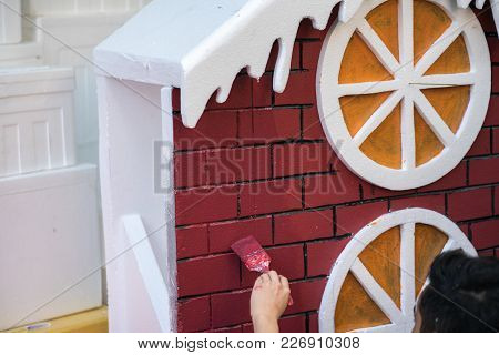 Man Painting Play House Made Of Styrofoam Closeup