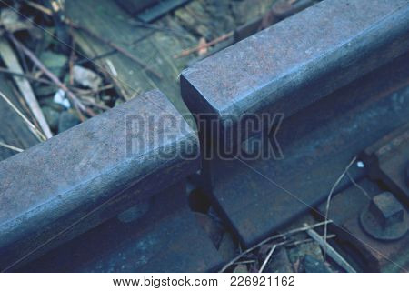 Gap With Nut And Screw On The Old Rusty Rail.  Rusty Train Railway Detail, Oiled Sleepers And Stones