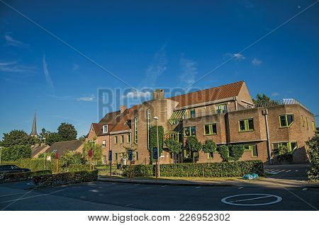 Tielt, Belgium - July 02, 2017. Street With Public School Brick Building At Sunset In Tielt. Charmin