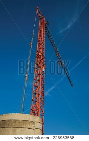 Close-up Of Crane In A Construction Area At Sunset And Blue Sky In Tielt. Charming And Quiet Village