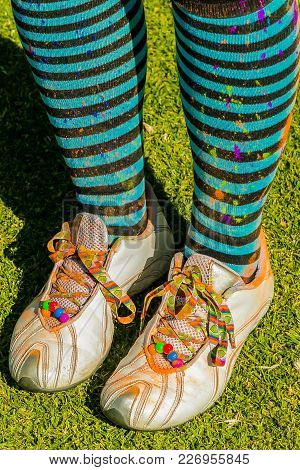 Close Up Of Pair Of Stripy Stocks Covered In Powder Paint, Young Person At The Color Run