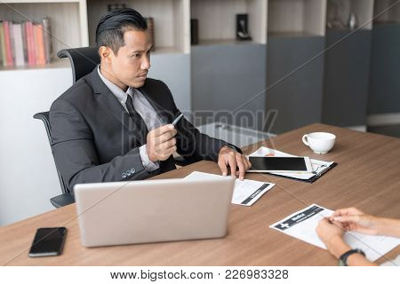 Business People Have A Meeting With Filing Sick Leave In Office. Setup Studio Shooting.