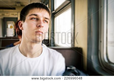 Sad Young Man Sit In The Train By The Window